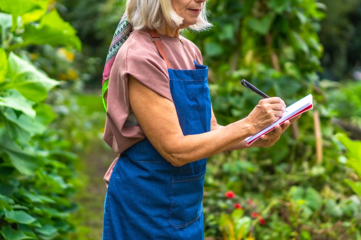 woman in garden with checklist