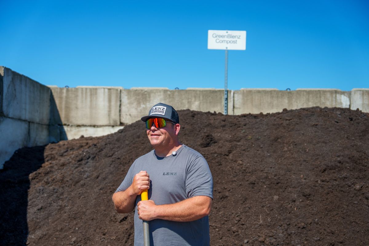 man standing in front of compost